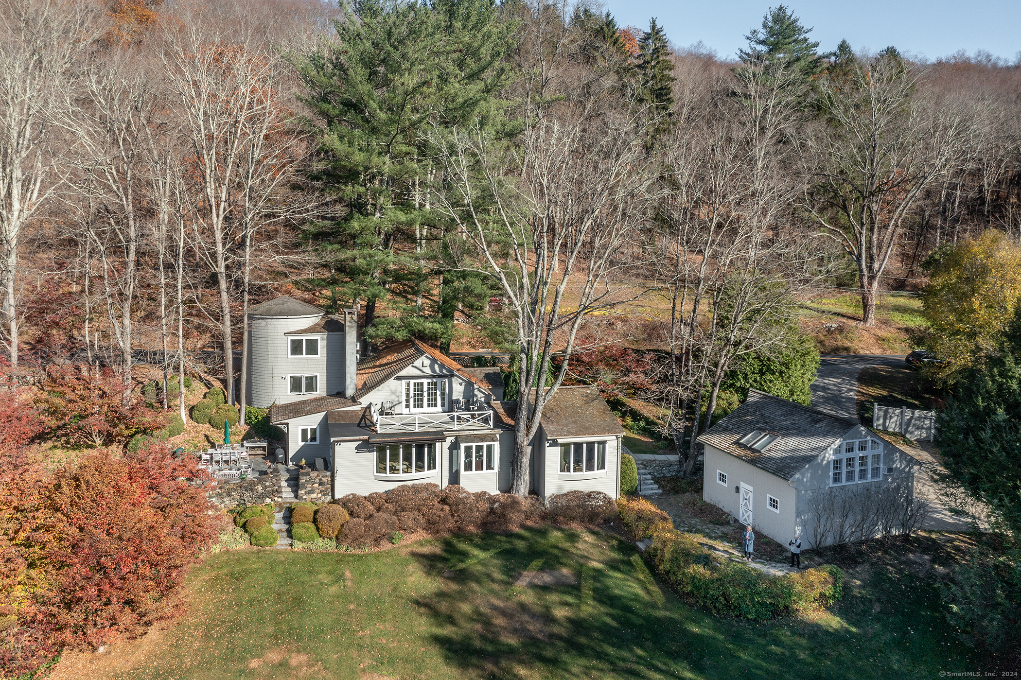 a front view of a house with trees and plants