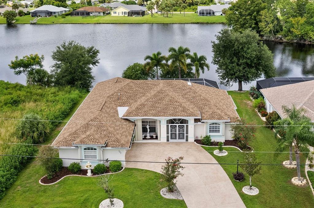 an aerial view of a house with garden space and lake view