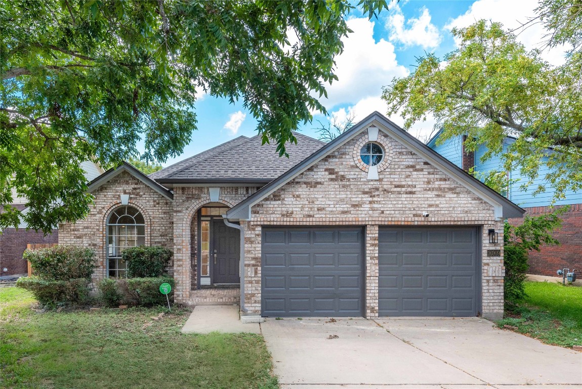 a front view of a house with a yard and garage