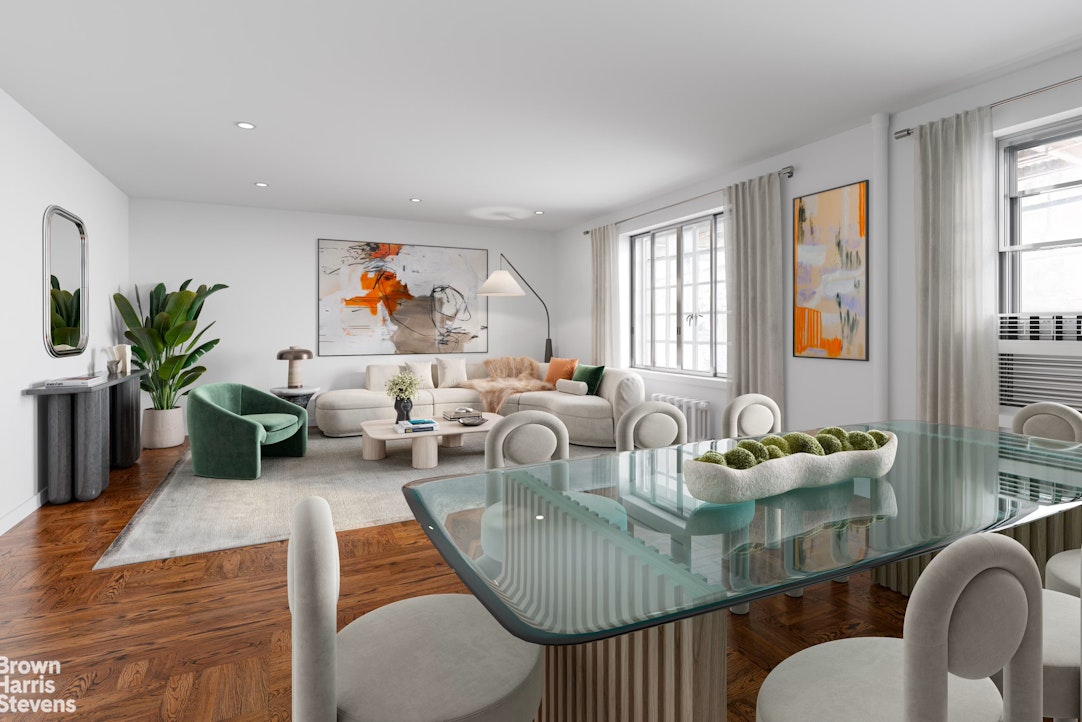 a living room with furniture kitchen view and a window