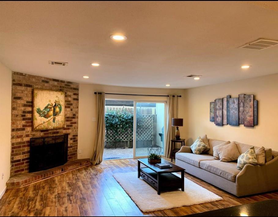 a living room with furniture a large window and a flat screen tv