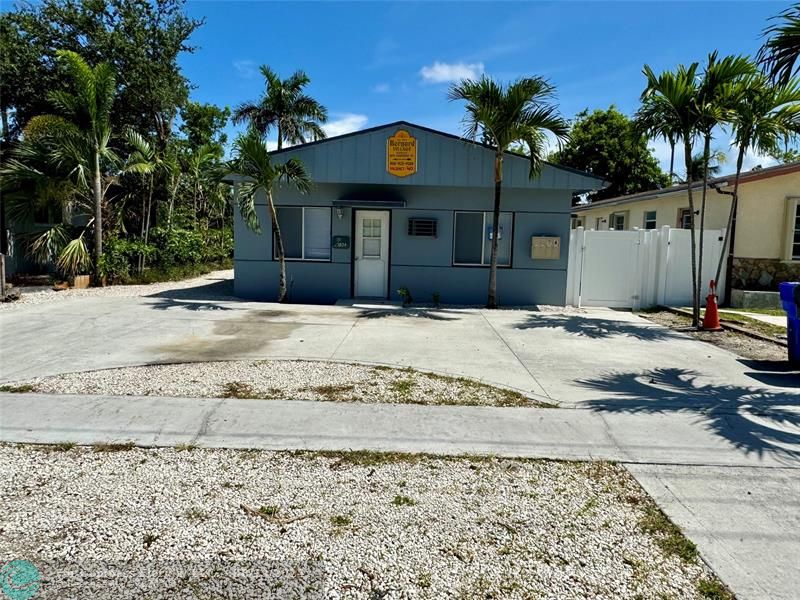 a view of a house with a yard and a garage