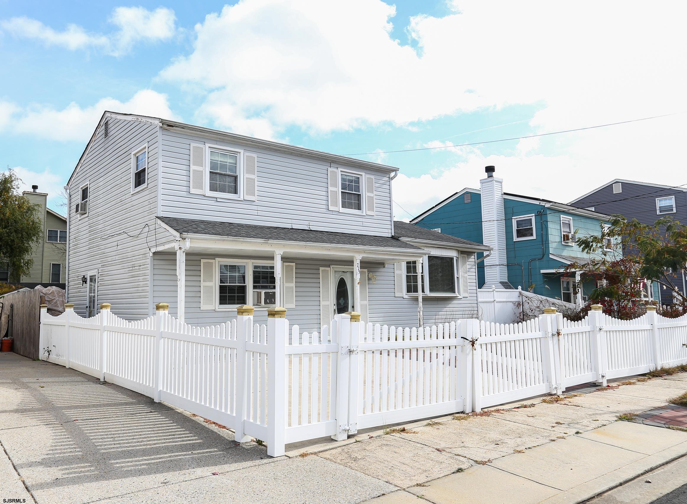 a front view of a house with wooden fence