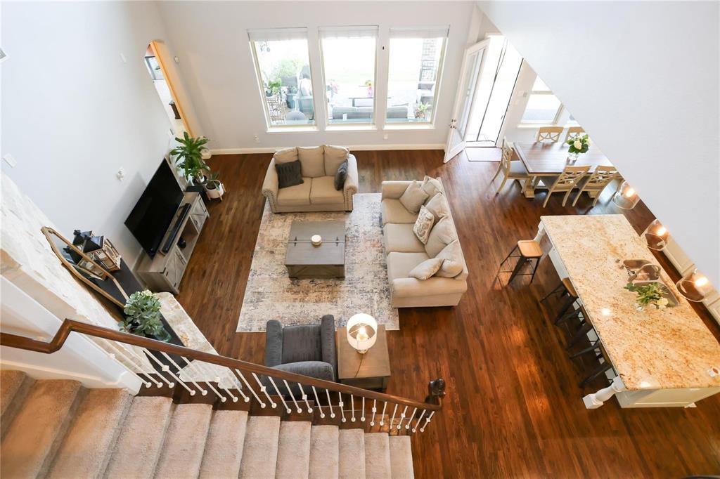 a view of living room with furniture and wooden floor