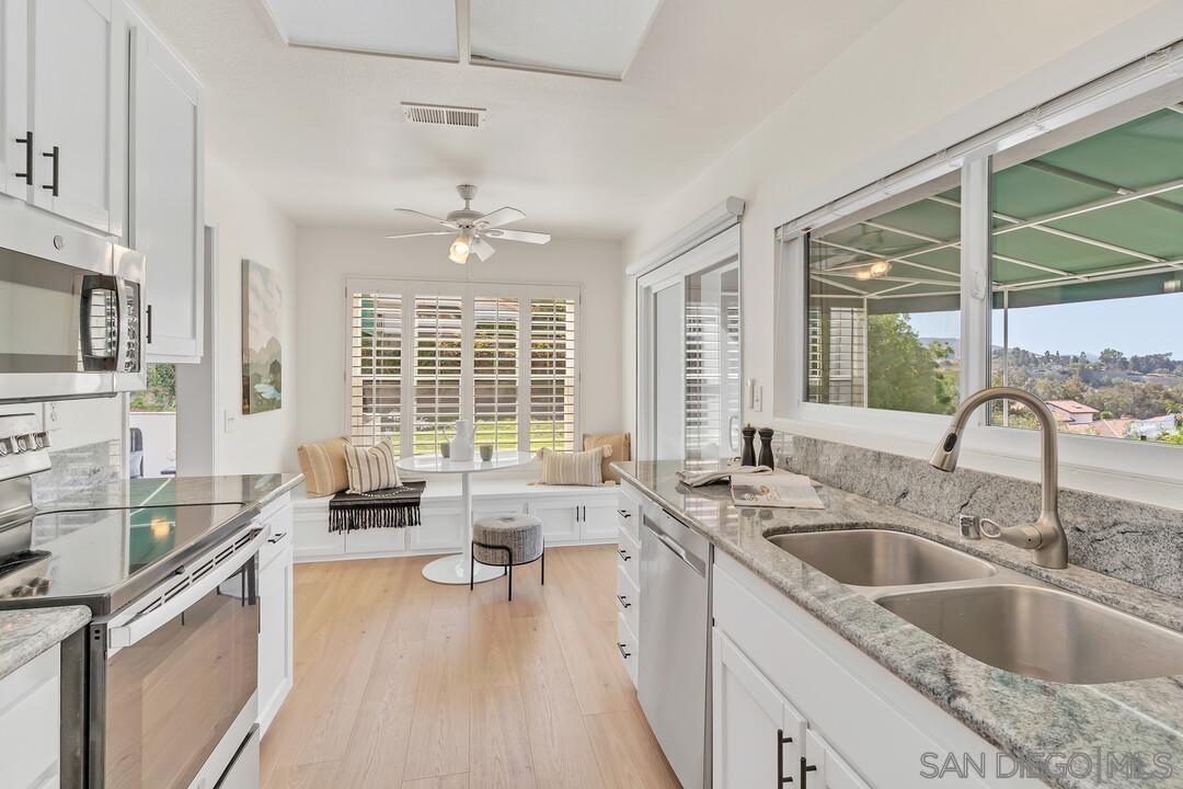 a kitchen with a sink stove and cabinets