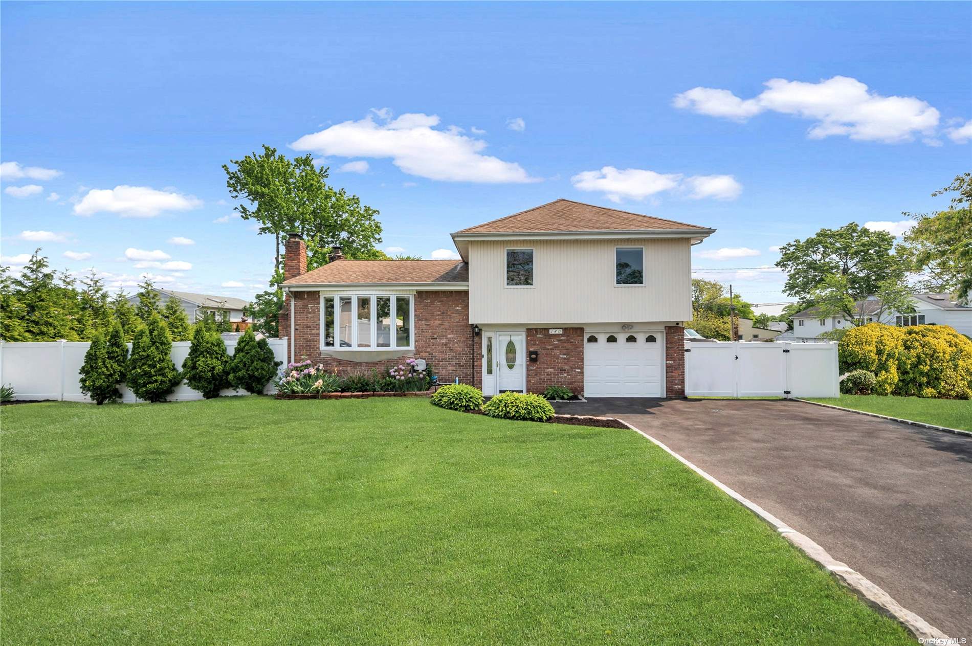 a view of a house with a yard and a garden