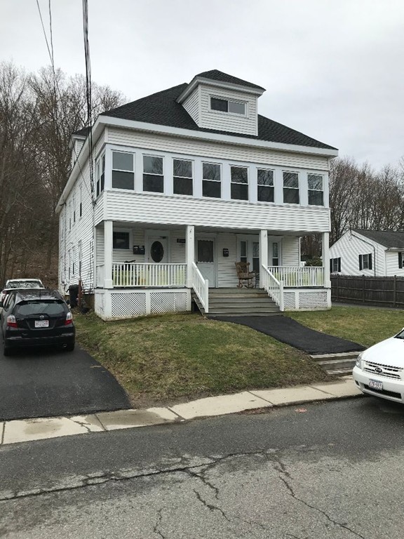 a view of a car parked in front of a house