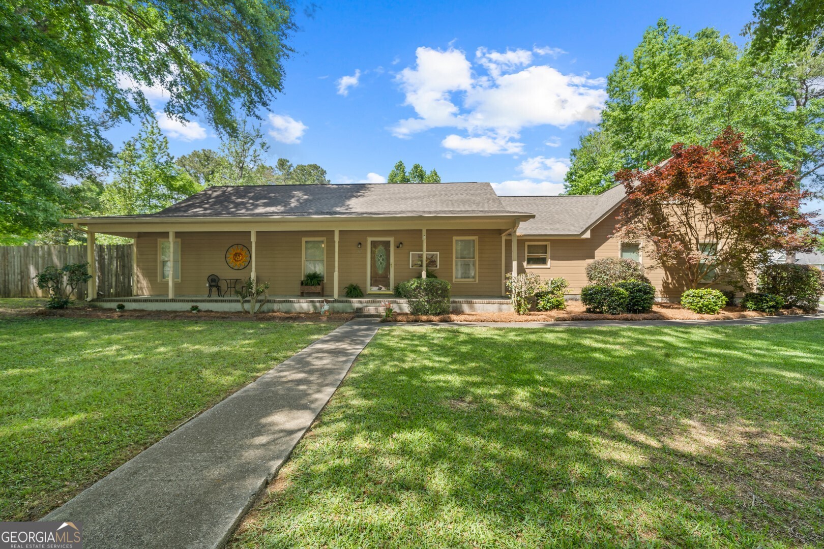 a front view of a house with a garden