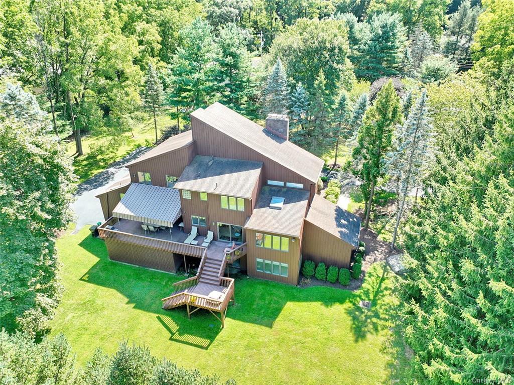 aerial view of a house with a yard patio and sitting area