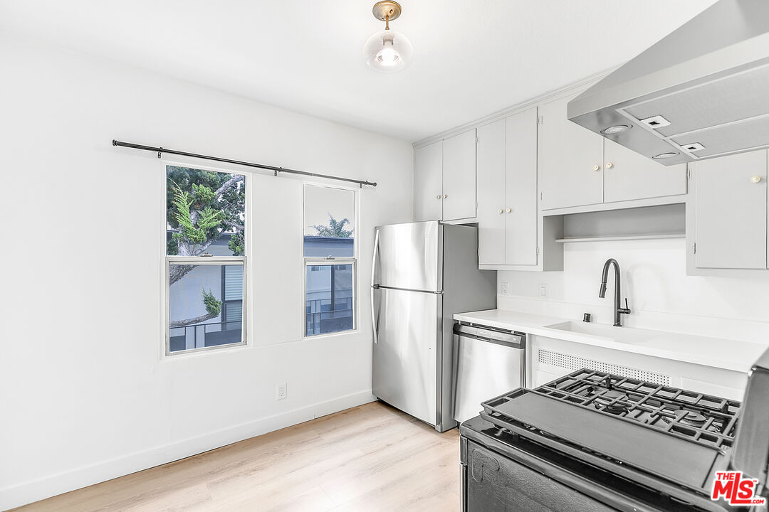 a kitchen with a refrigerator and a sink