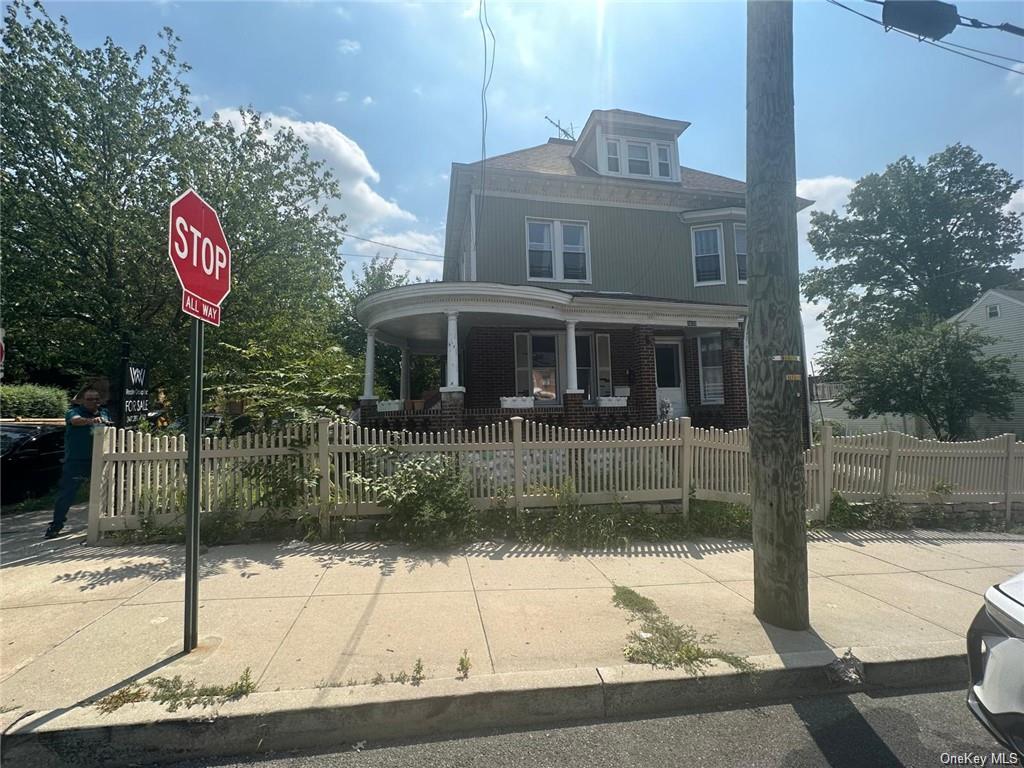 a view of a brick house with a sign on the road