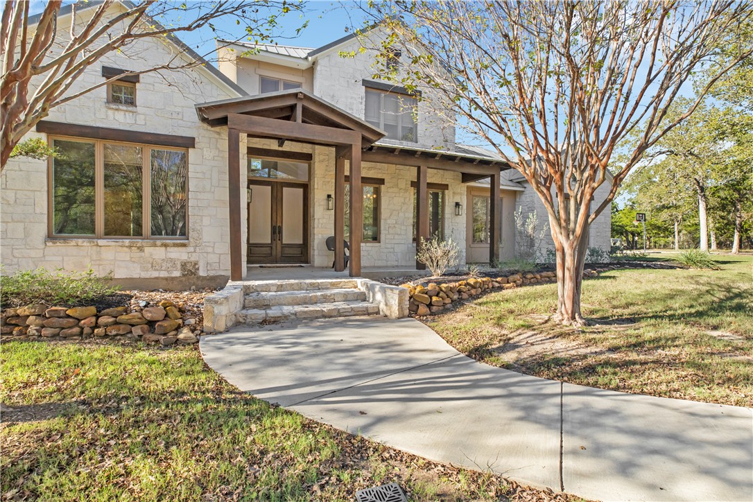 View of front of home featuring a porch and a fron