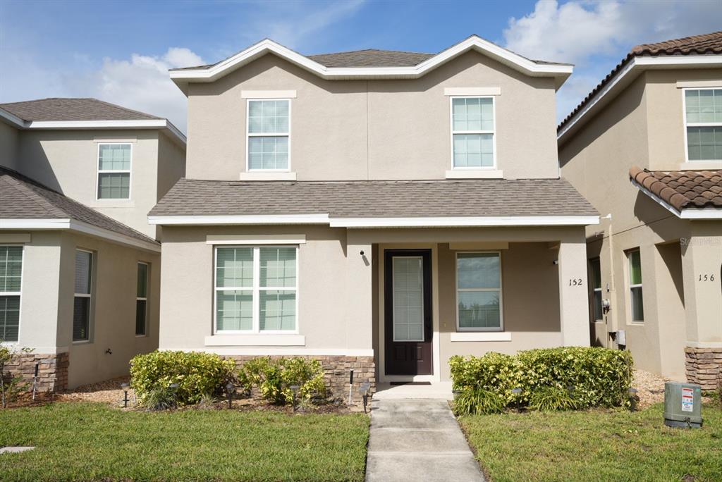 a front view of a house with a yard