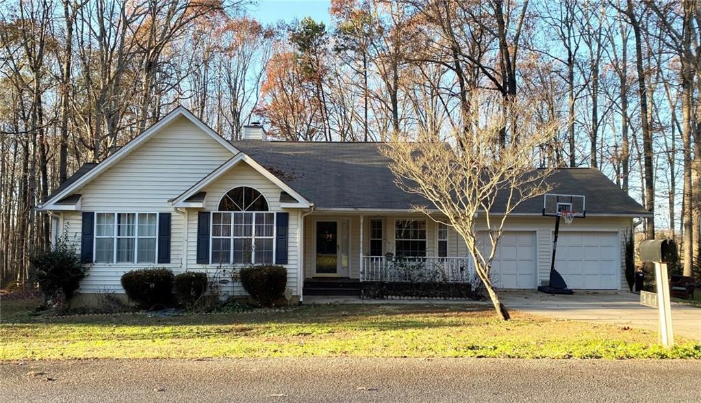 a front view of a house with swimming pool and porch