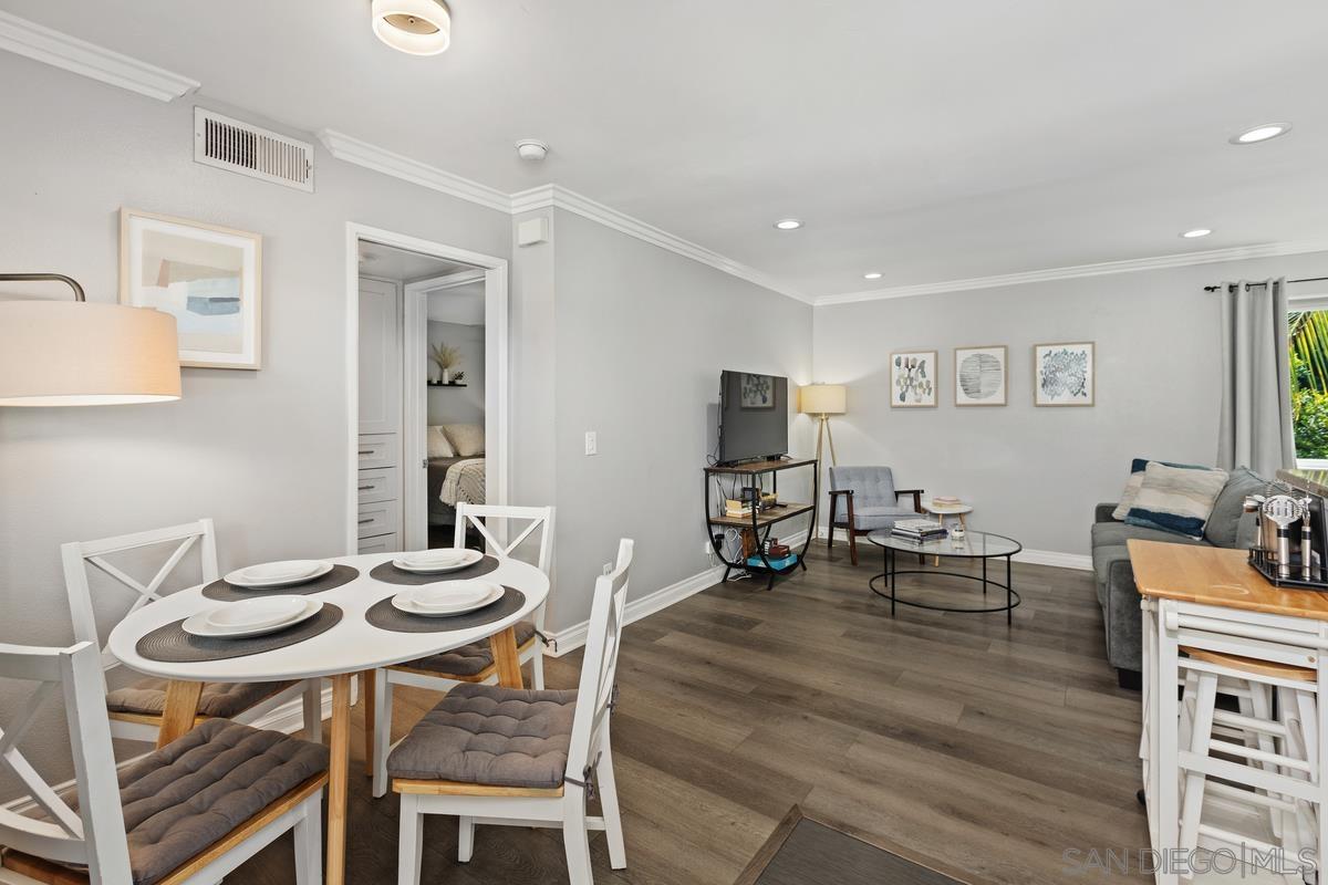 a view of a dining room with furniture and wooden floor