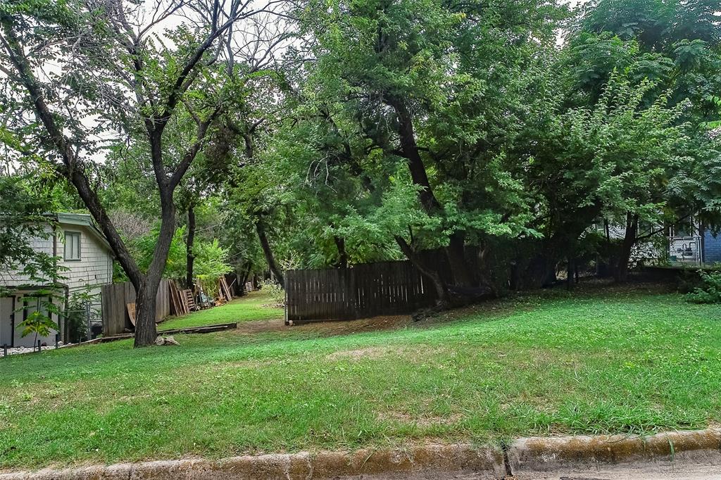 a view of a backyard with large trees