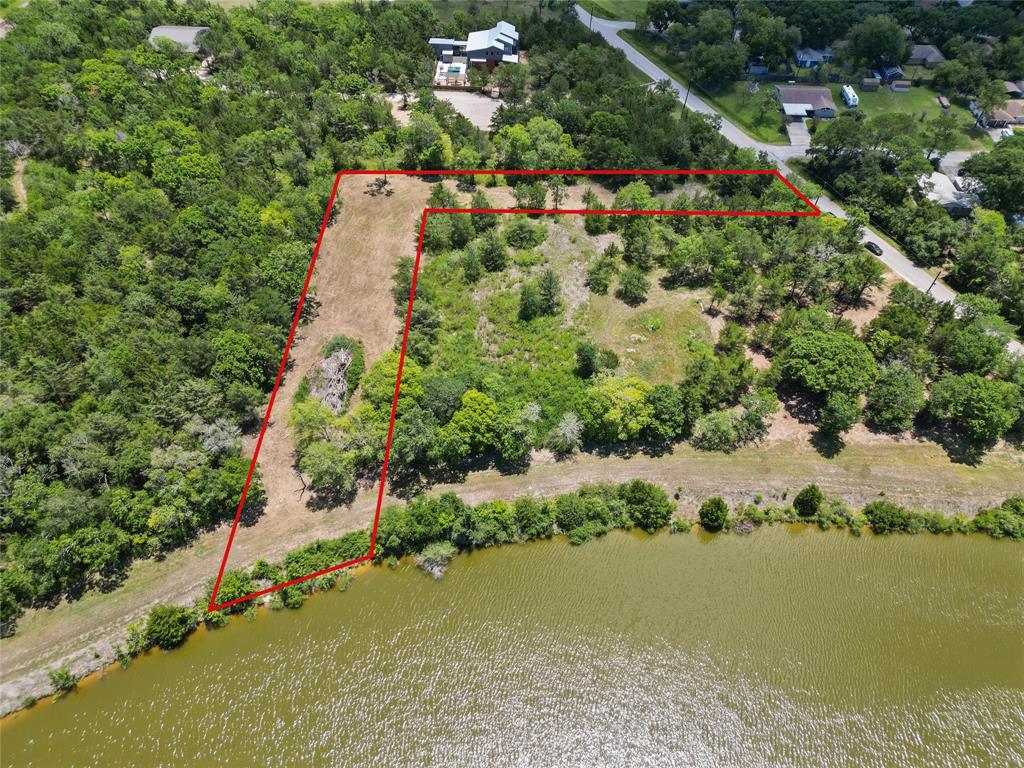 an aerial view of a houses with a lake view