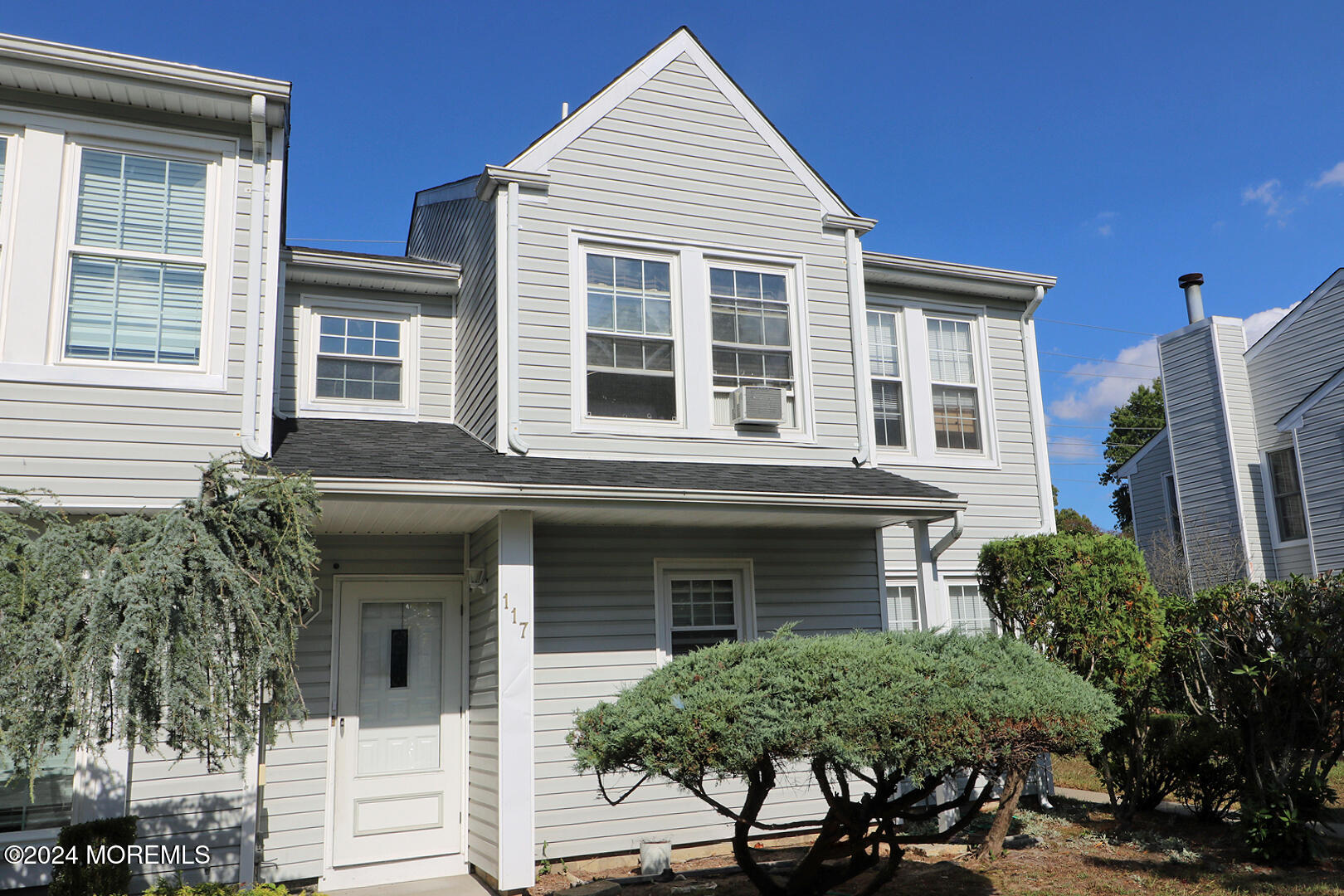 a view of a house with more windows and plants