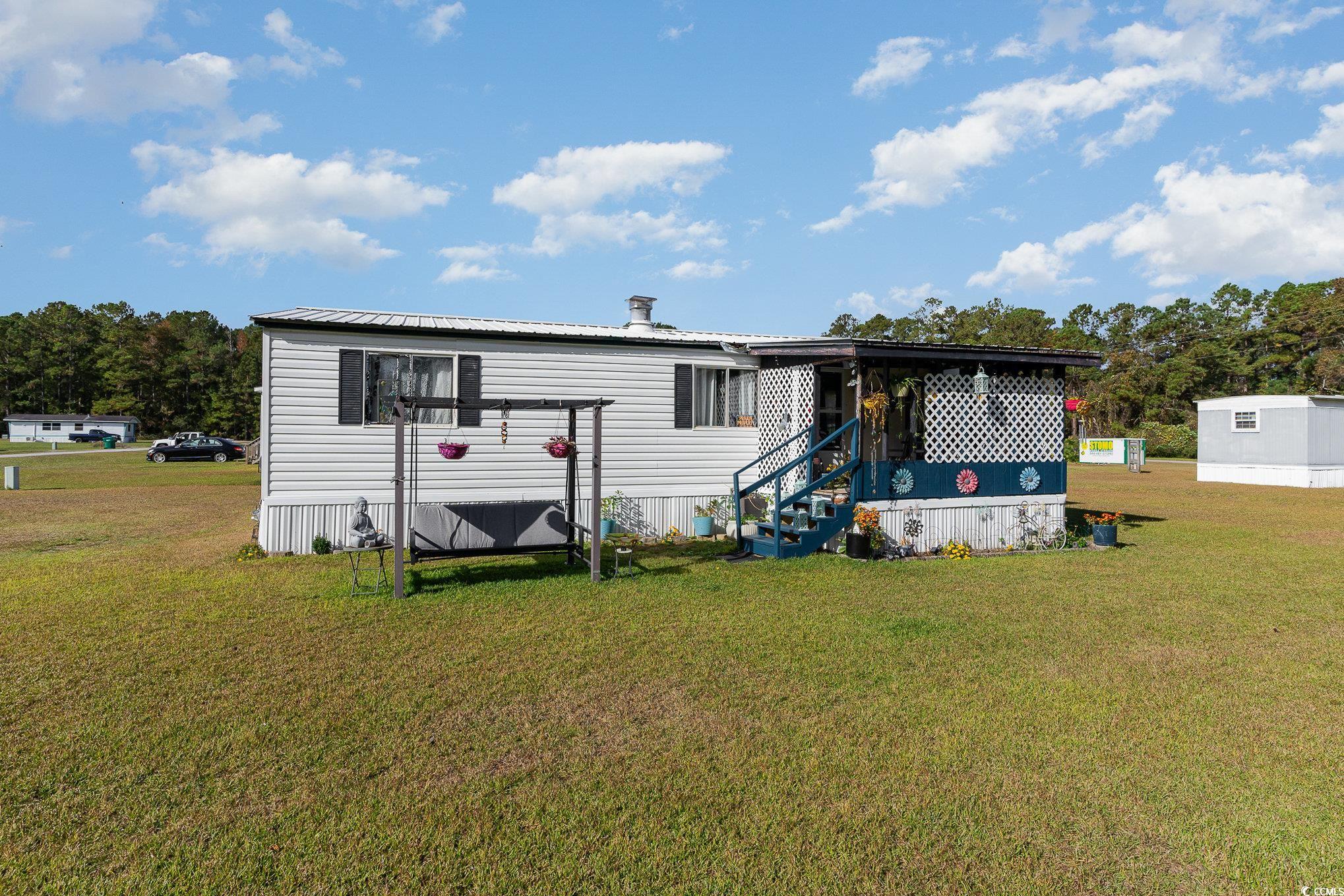 Back of house featuring a lawn