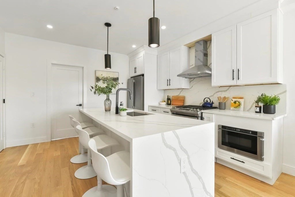 a kitchen with stainless steel appliances kitchen island wooden cabinets and stove