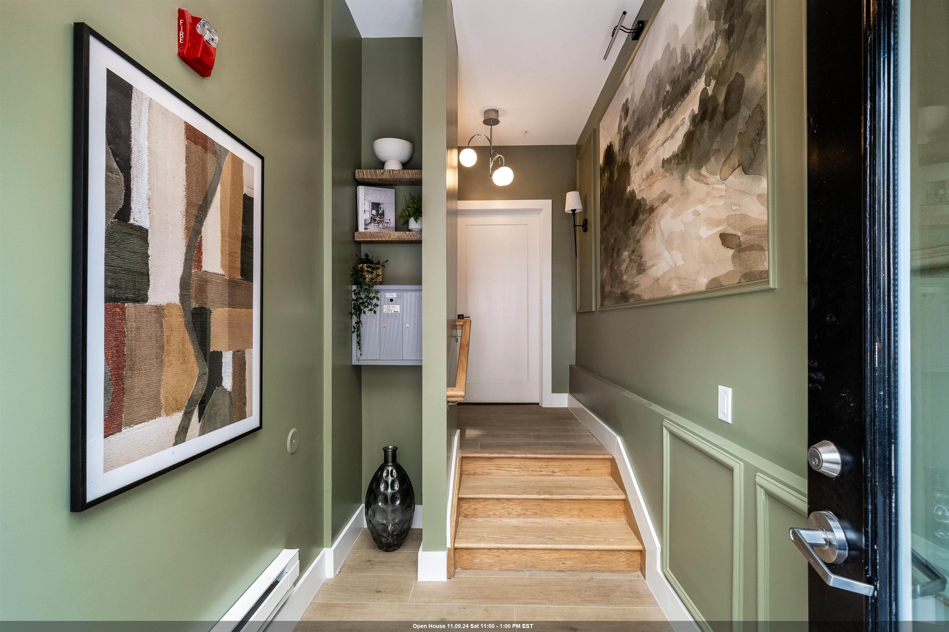 a view of a hallway with wooden floor and windows