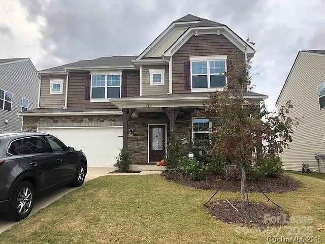 a view of a house with a yard