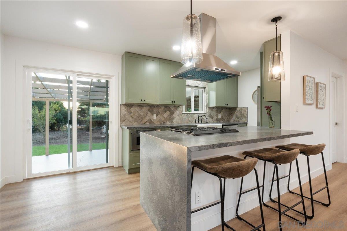 a kitchen with stainless steel appliances kitchen island a chandelier