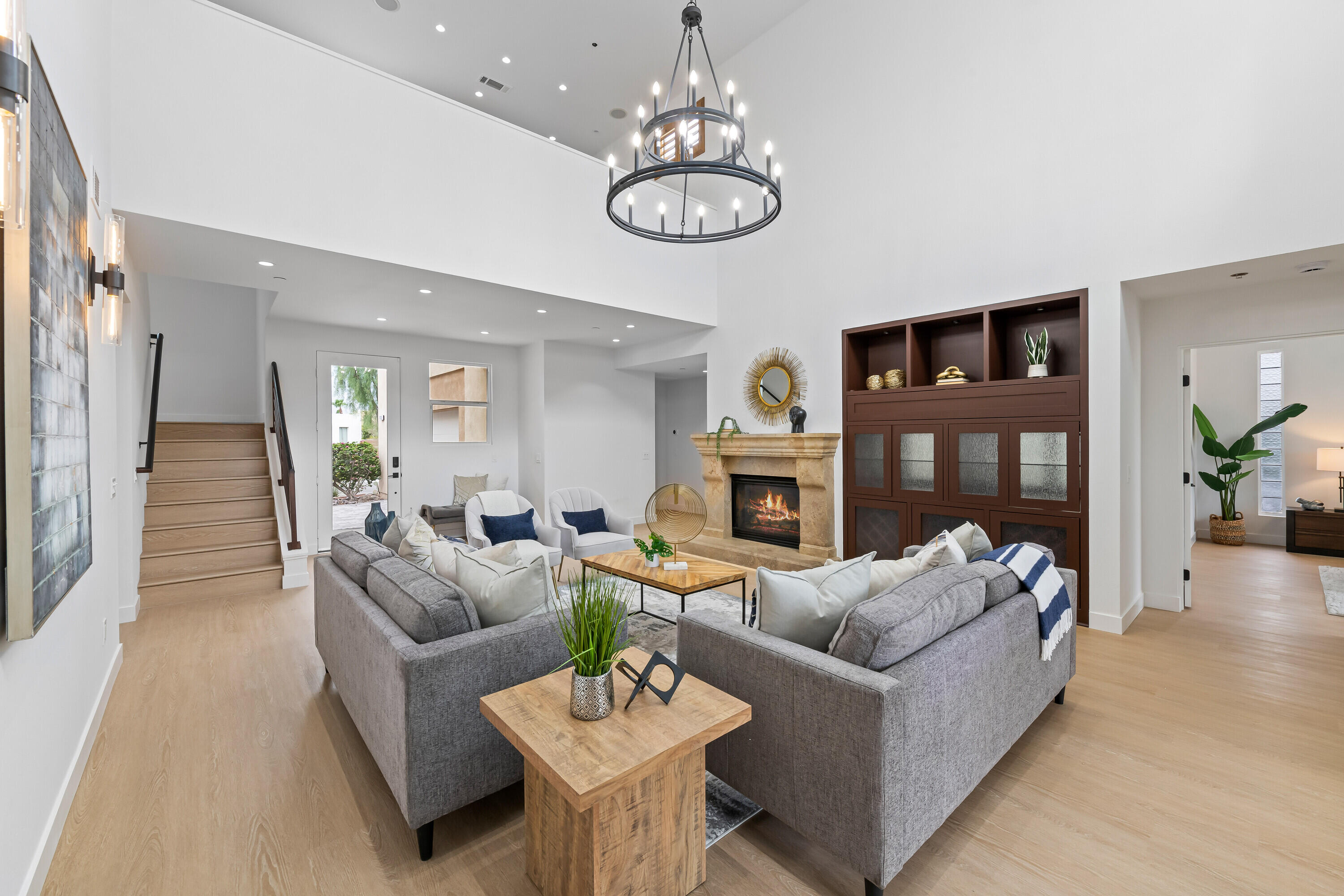 a living room with furniture a fireplace and a chandelier