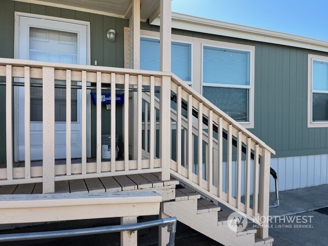 a view of wooden deck with a small house