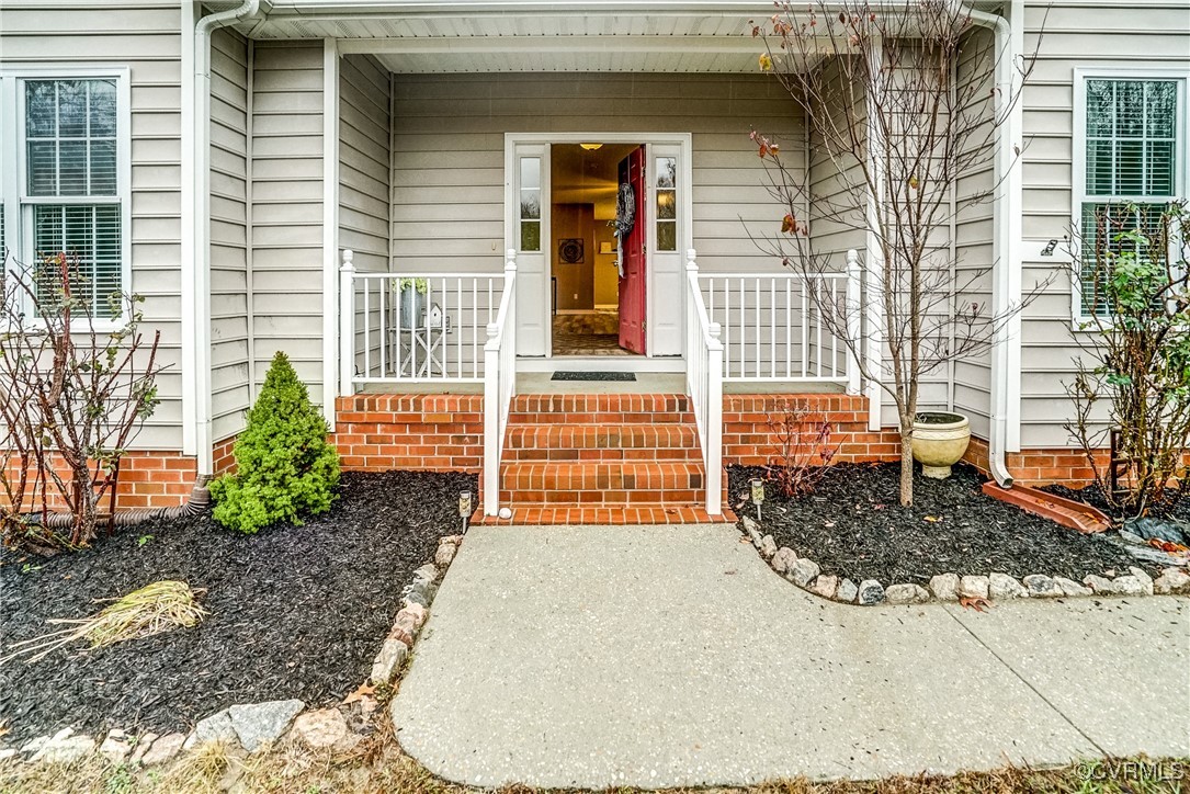 View of exterior entry with covered porch