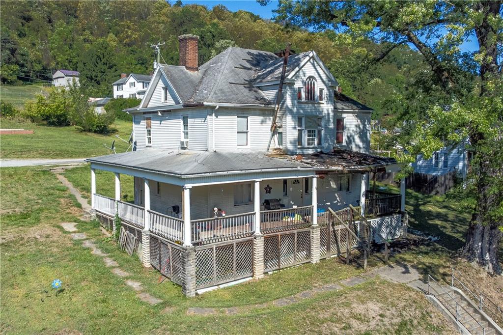 a view of a house with a yard balcony and seating area