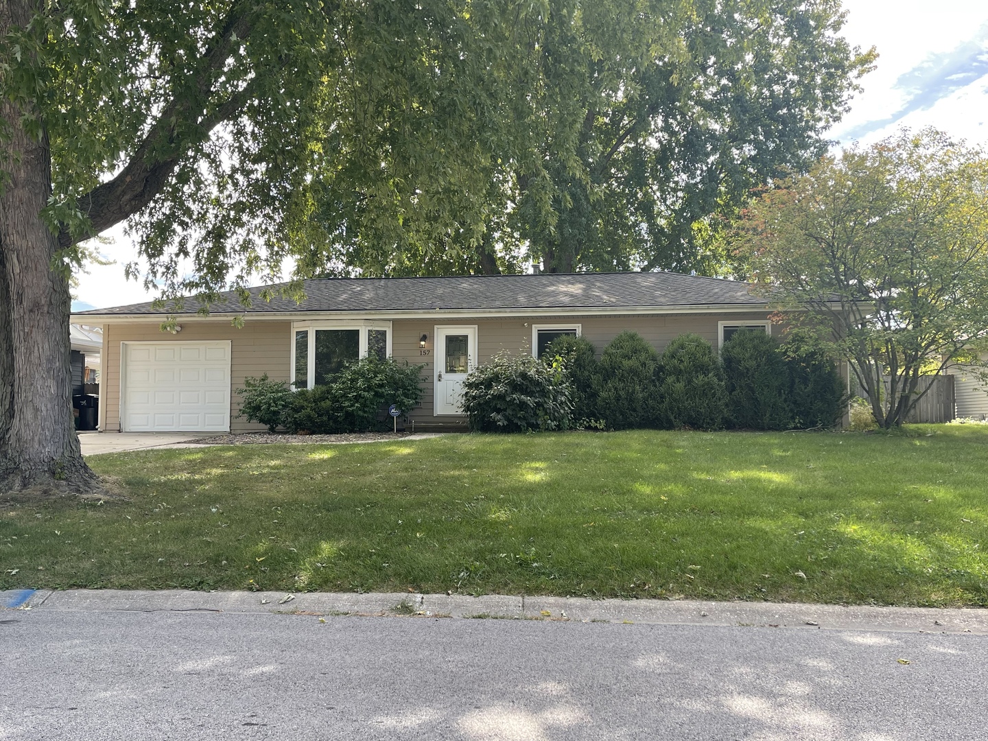 a front view of a house with a garden