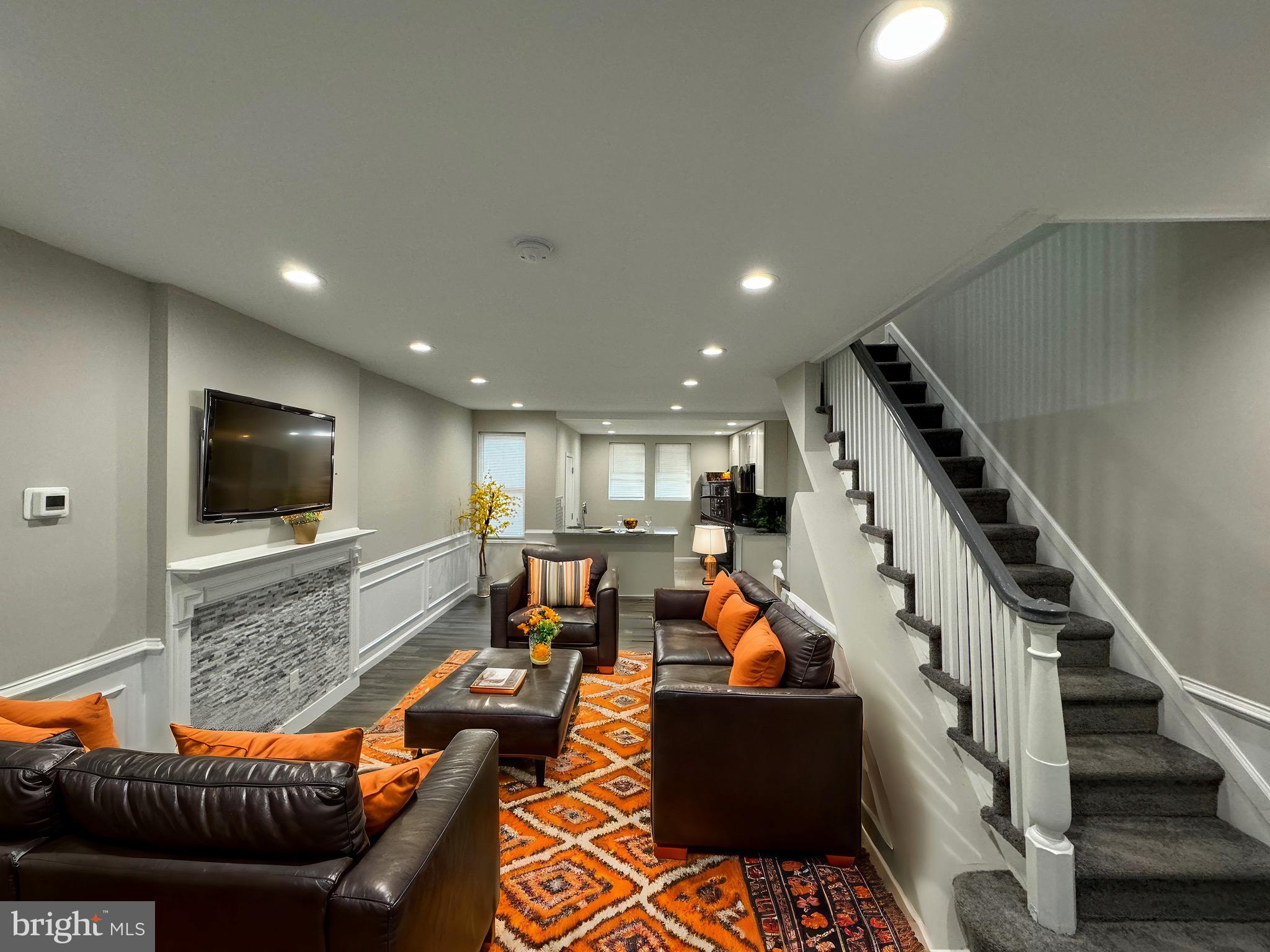 a living room with furniture and a flat screen tv