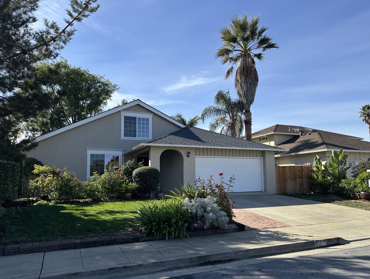 a front view of a house with a garden