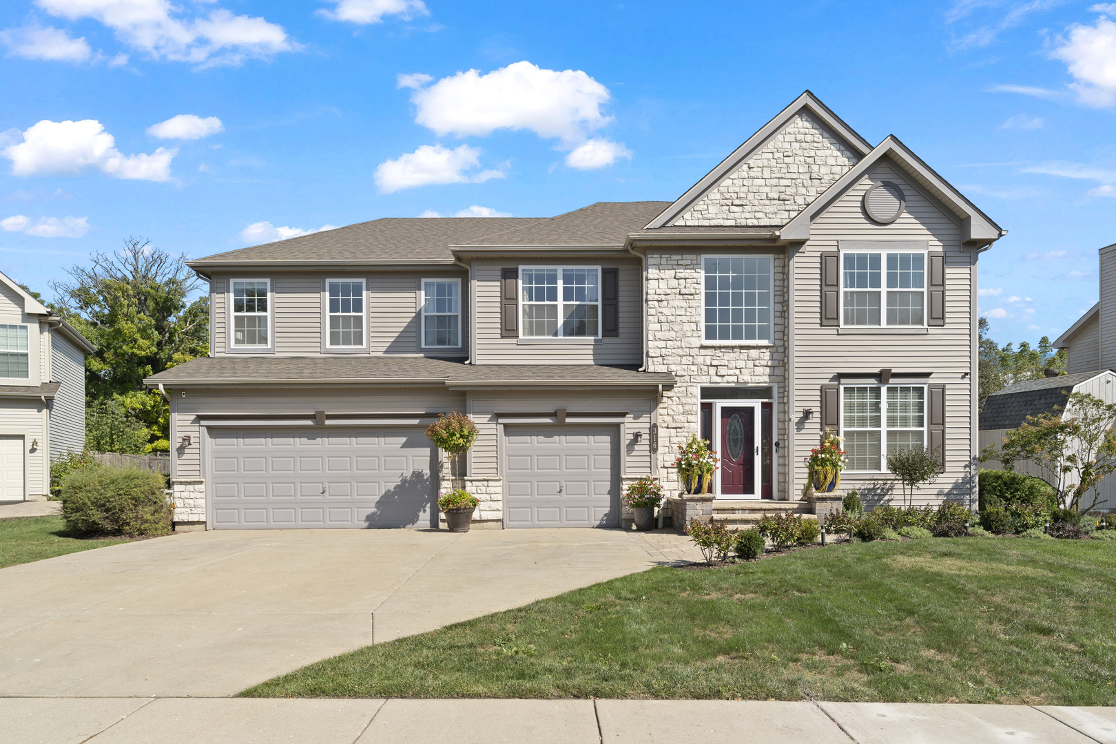 a front view of a house with a yard and garage