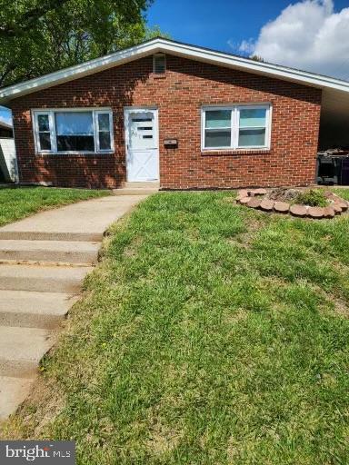 a front view of house with yard and outdoor seating