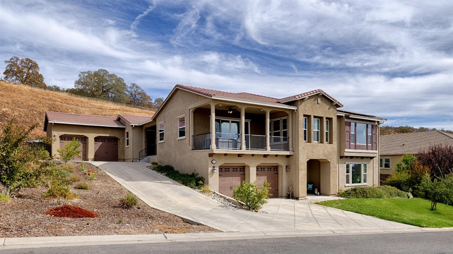 a front view of a house with a garden