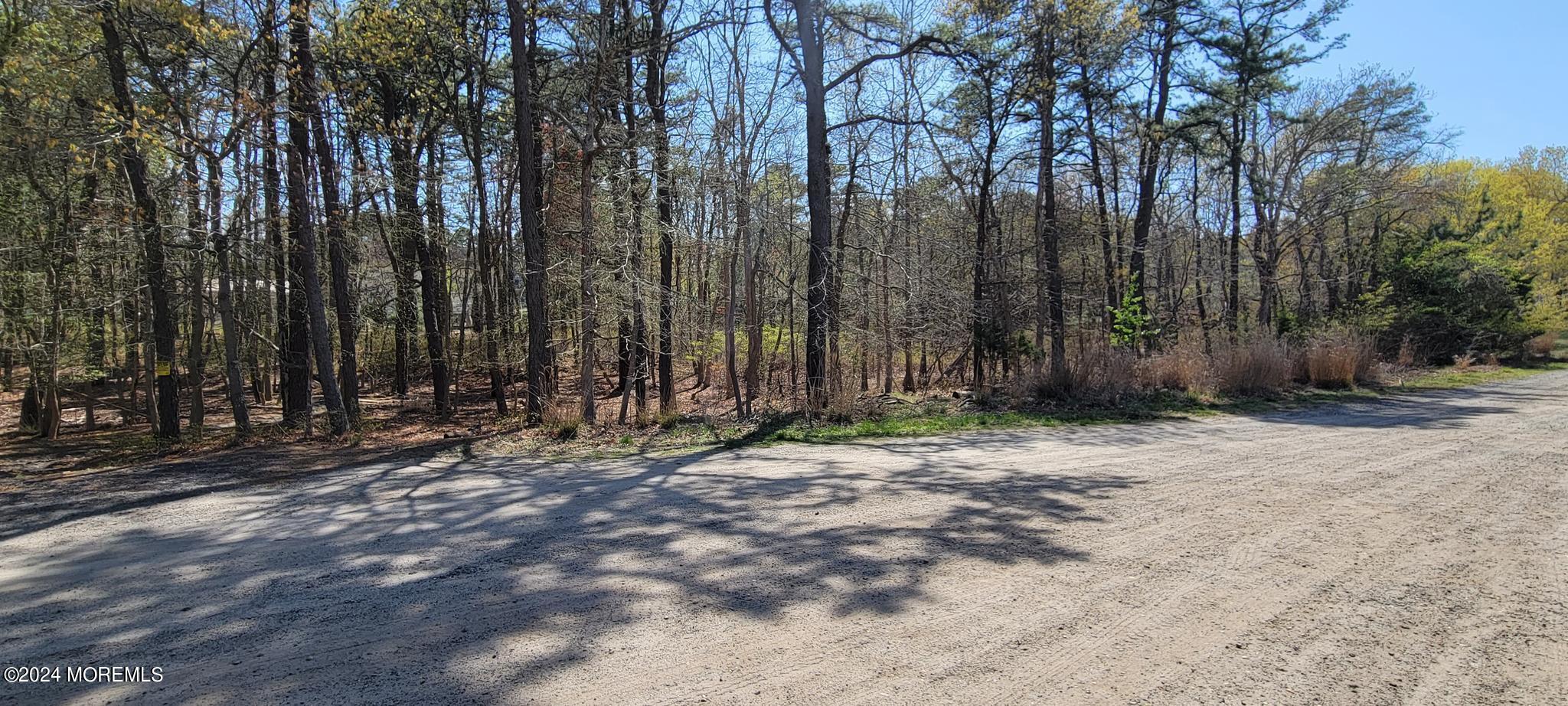 a wooden fence with trees in the background