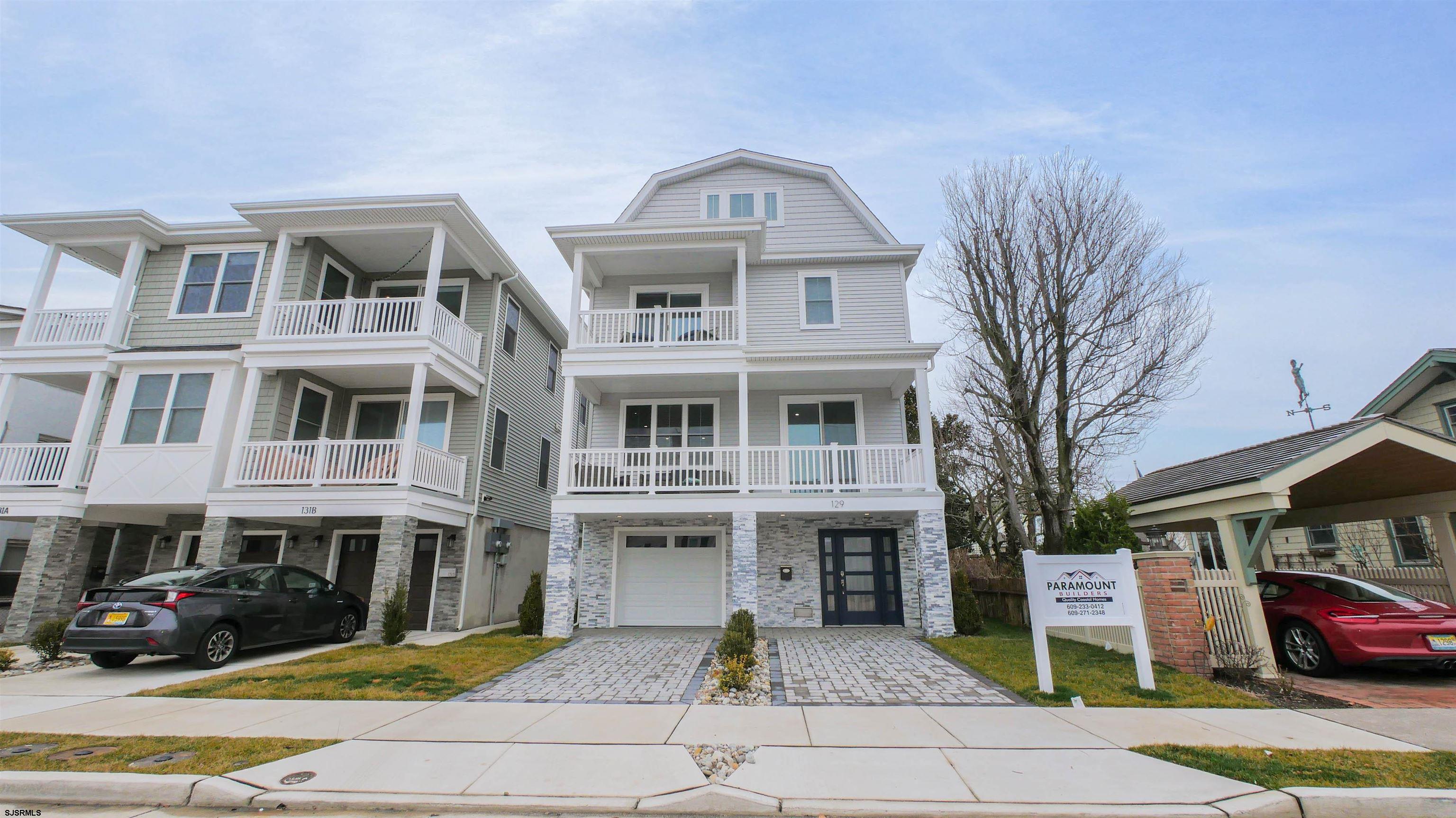 a front view of a residential apartment building with a yard