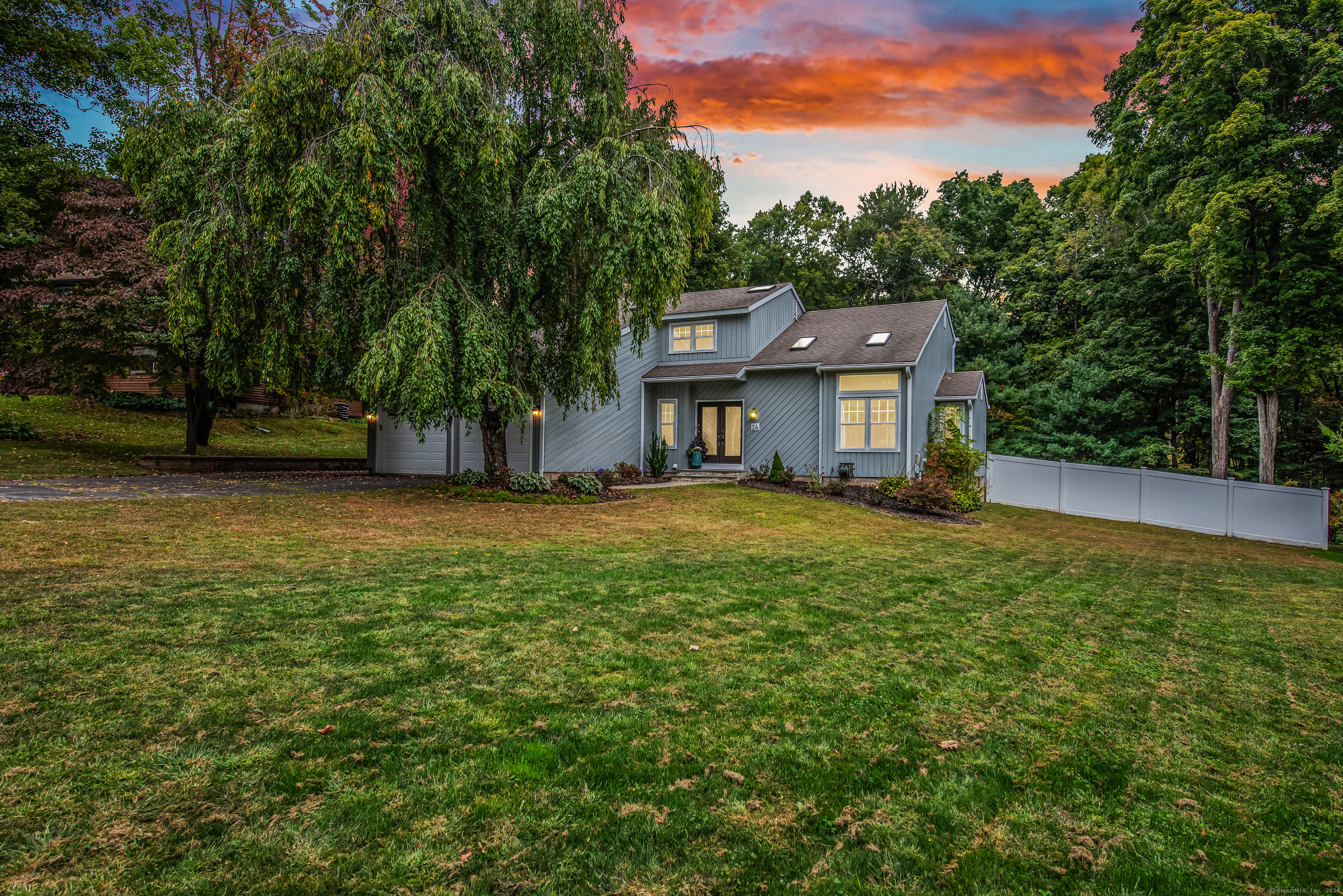 a front view of a house with a garden