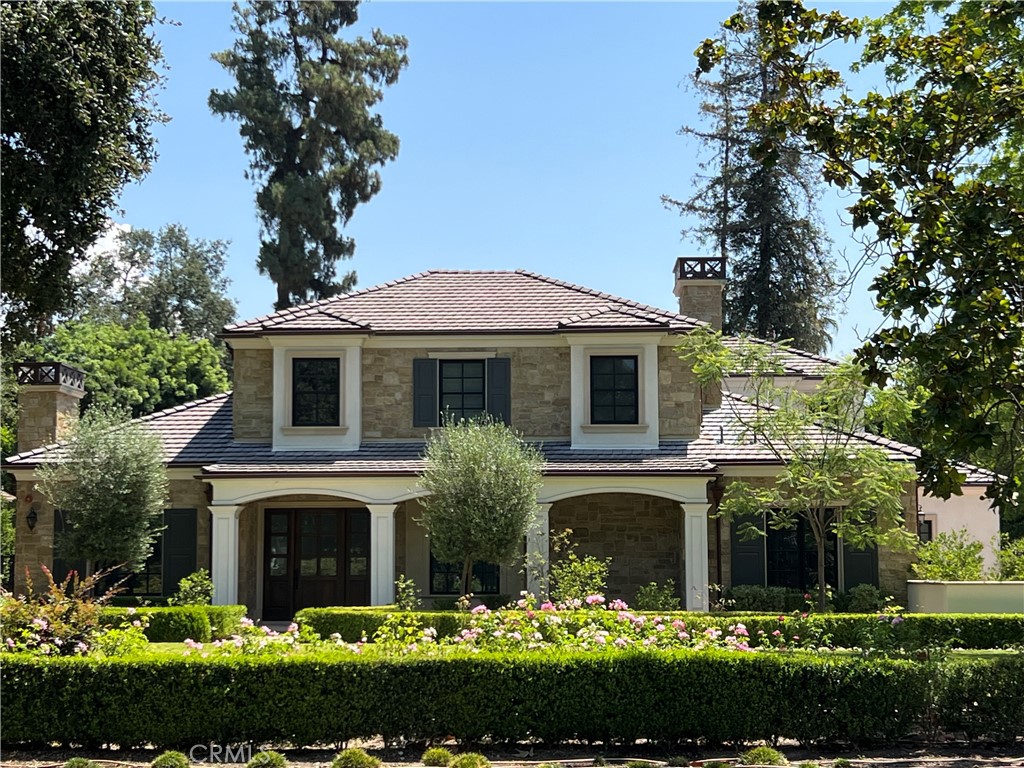 a front view of a house with a garden