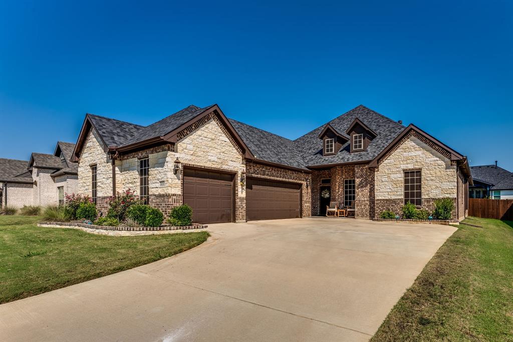 a front view of a house with a yard and garage