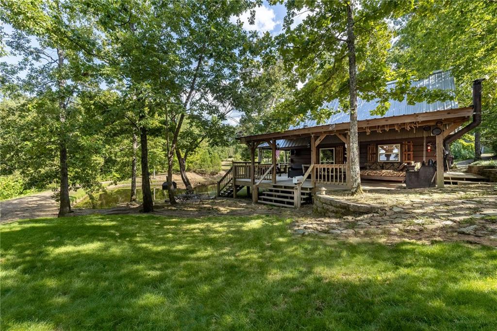 a view of a house with backyard porch and sitting area