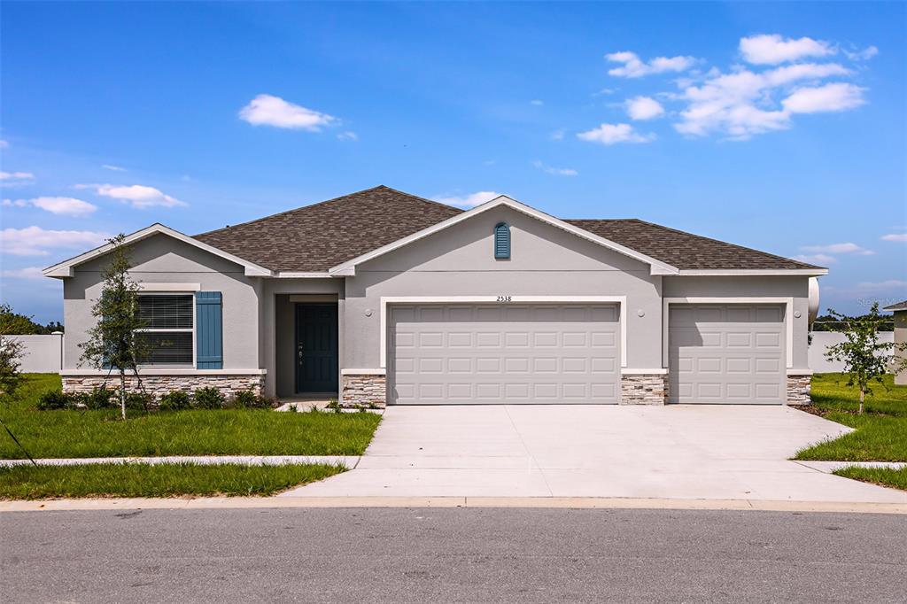 a front view of house with yard and green space