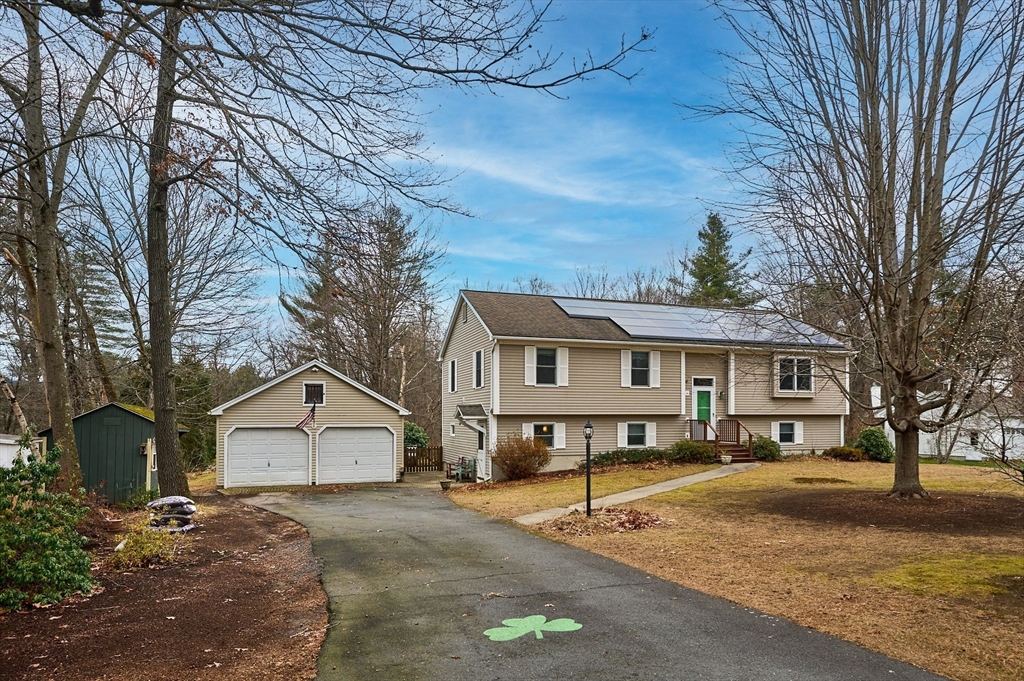 a view of a house with a yard covered in snow