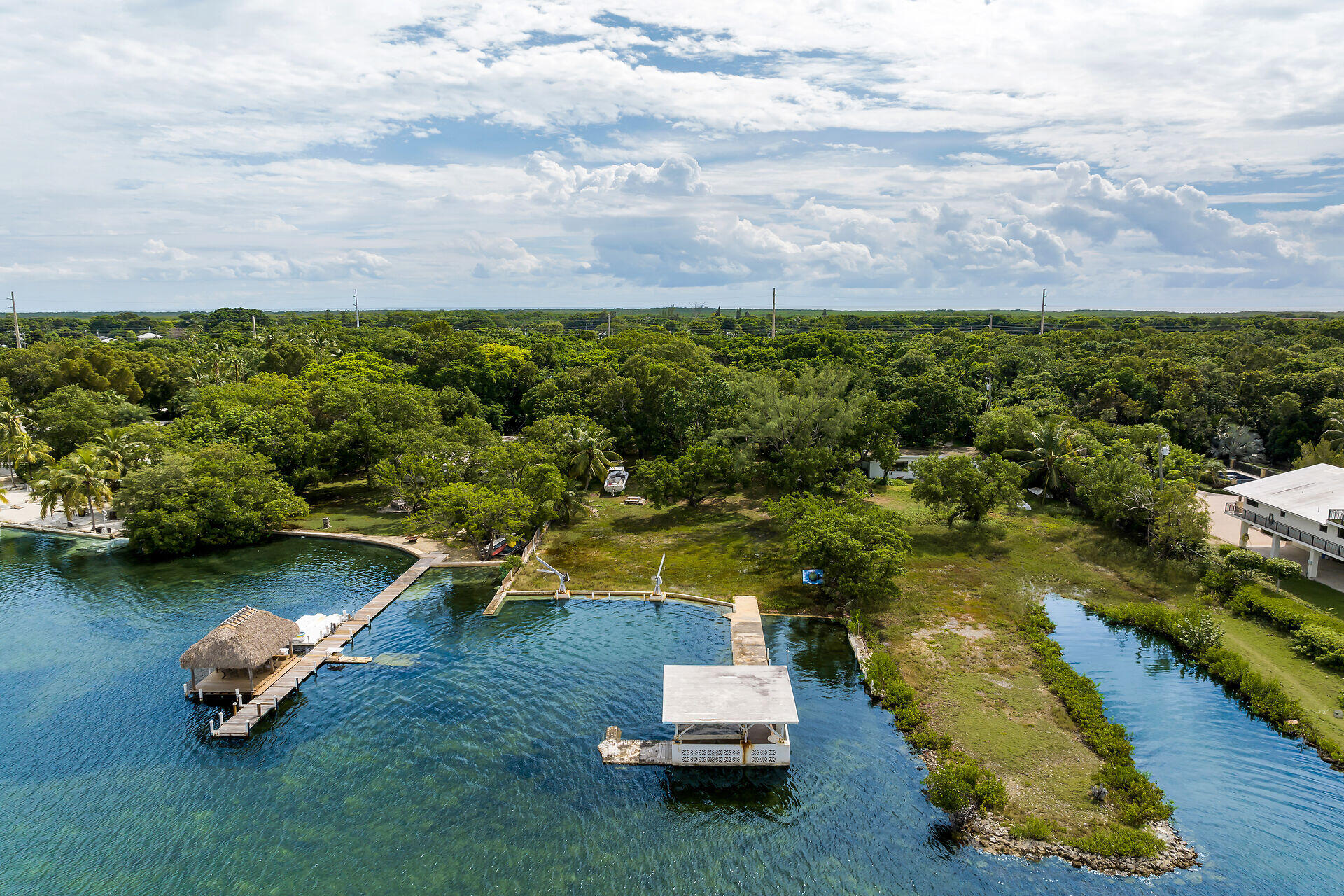 an aerial view of a house with a garden and lake view