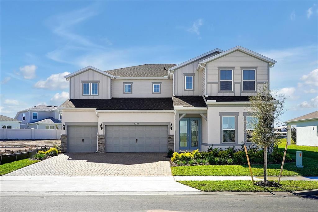 a front view of a house with a yard and garage