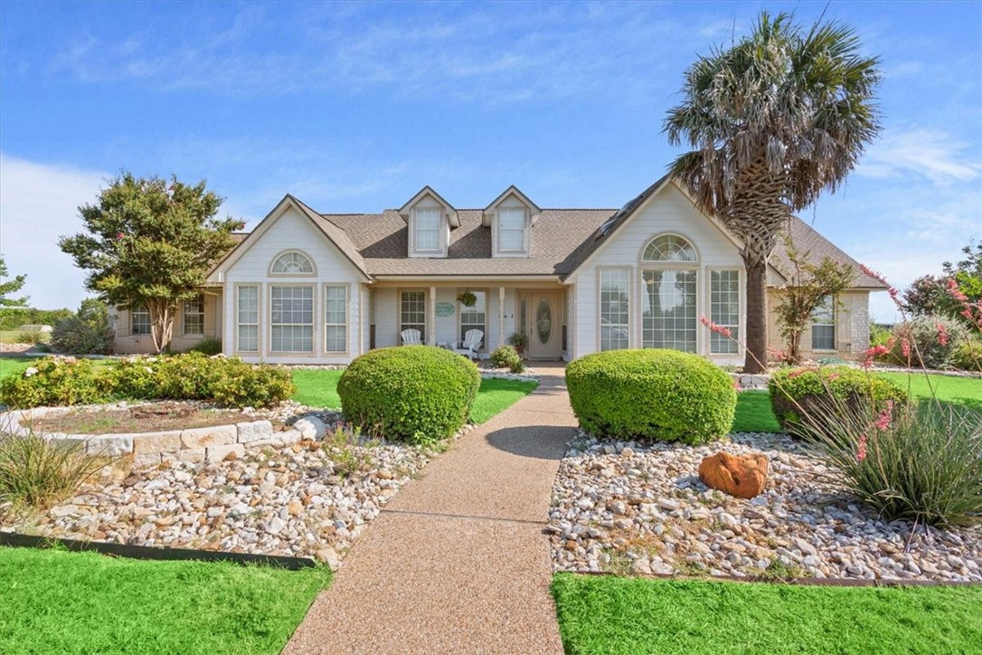 a front view of a house with garden