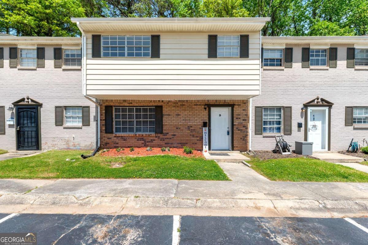 a house that has a tree in front of it