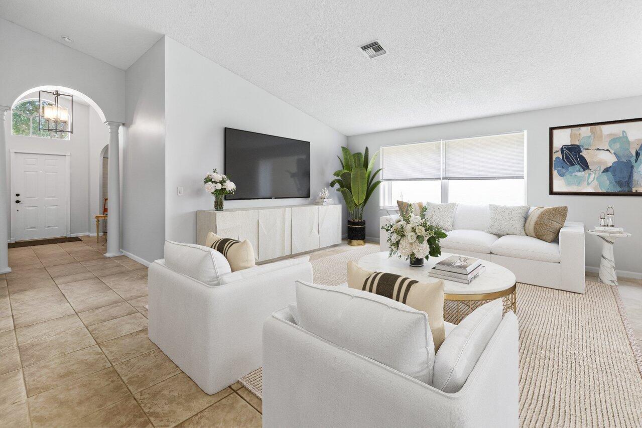 a living room with furniture and a flat screen tv